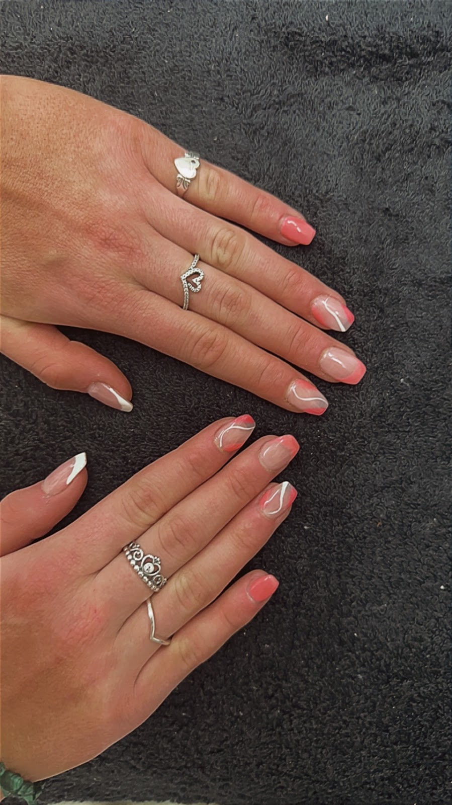 Coral nails with white tips on two hands