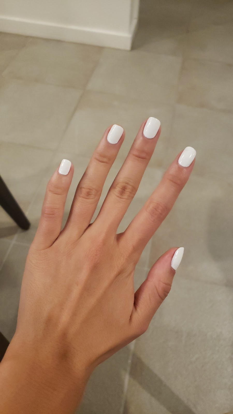 Clean white polish on short square nails