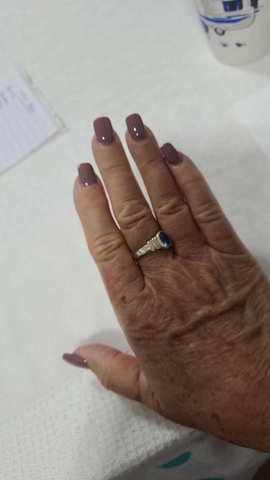 Mauve polish on short nails